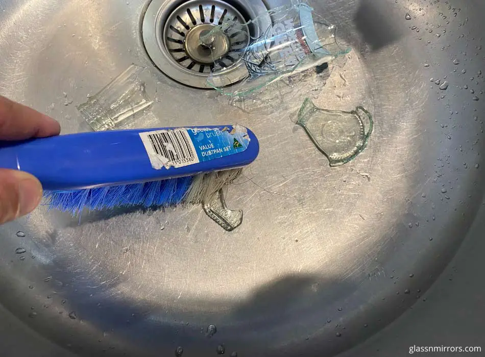 Pick up broken glass from sink