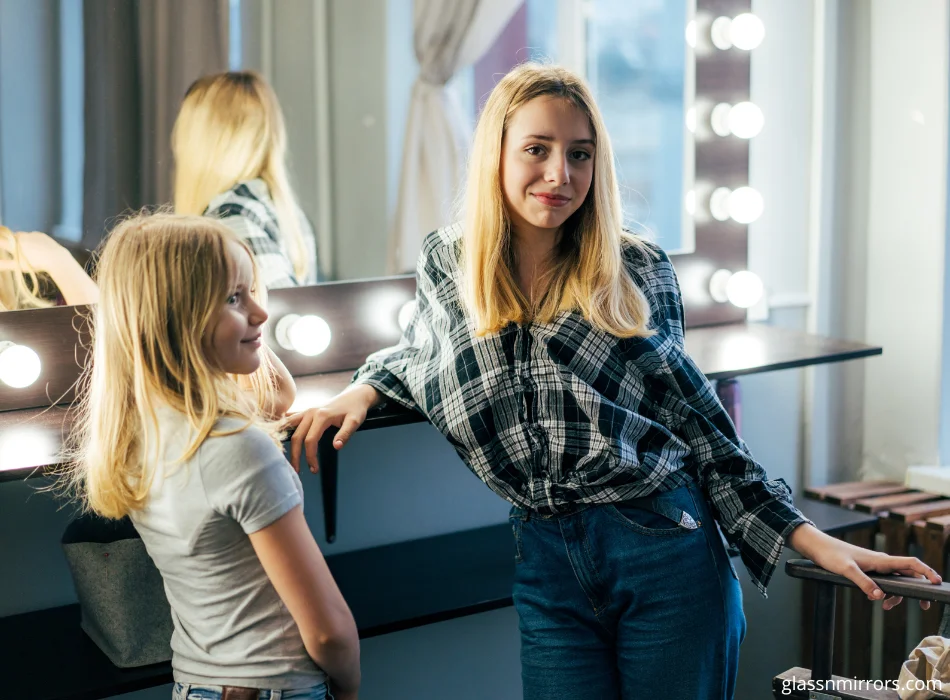 Girls in front of vanity mirror